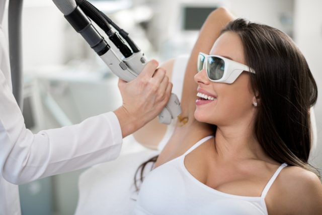 Young woman is having laser procedure.