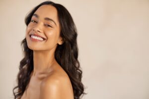 A woman smiling and showing the results of top skin treatments in South Miami
